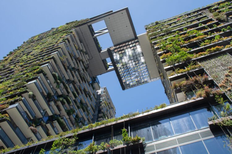 Green skyscraper covered with vertical gardens and ingenious sunlight reflection systems